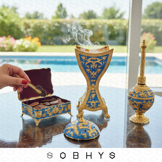 Luxury Arabic incense gift set Royal Blue Gold Sobhys limited edition
Decorative incense burner with intricate blue and gold design on a reflective surface, with 'SOBHYS' branding.