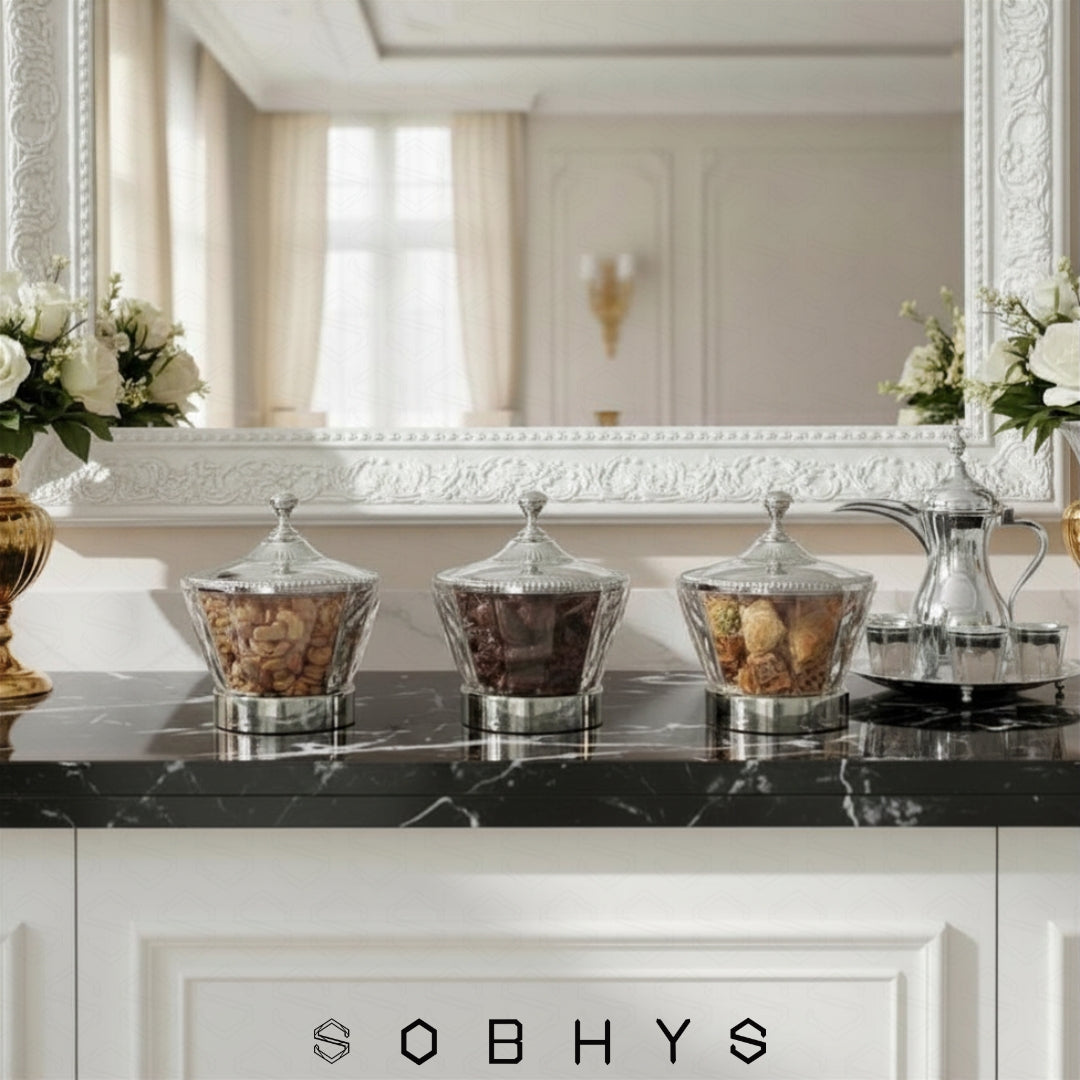 Decorative jars on a black marble countertop with 'SOBHYS' branding. Sobhys Crystal-Cut Acrylic Bowl Filled with Premium Dates – Ramadan and Eid Serving Bowl
