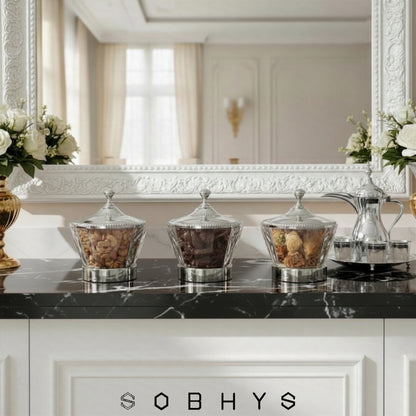 Decorative jars on a black marble countertop with 'SOBHYS' branding. Sobhys Crystal-Cut Acrylic Bowl Filled with Premium Dates – Ramadan and Eid Serving Bowl
