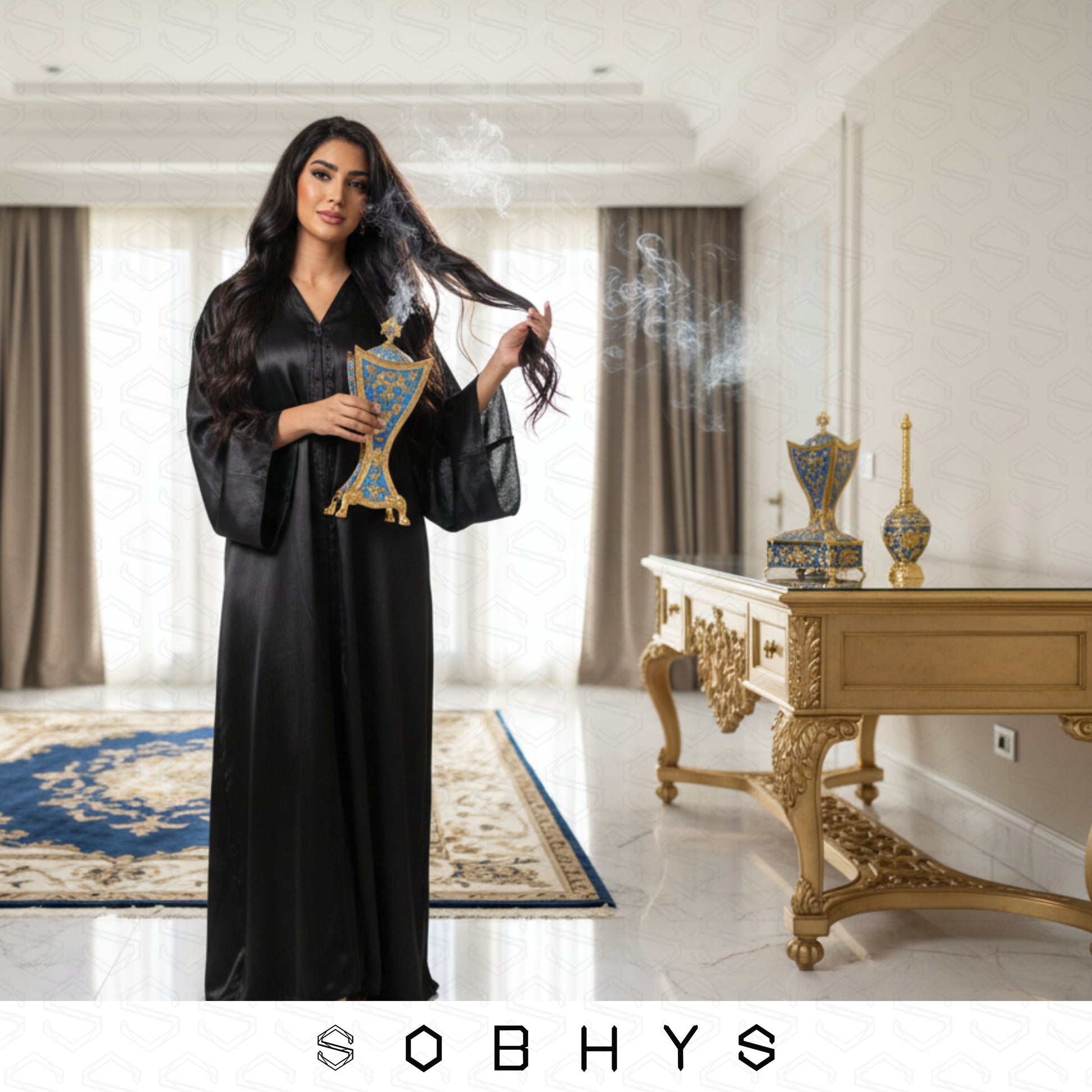 Arabic incense burner set unboxing velvet lined box Royal Blue Gold
Woman in a black abaya holding a decorative item in a luxurious room with 'SOBHYS' branding.